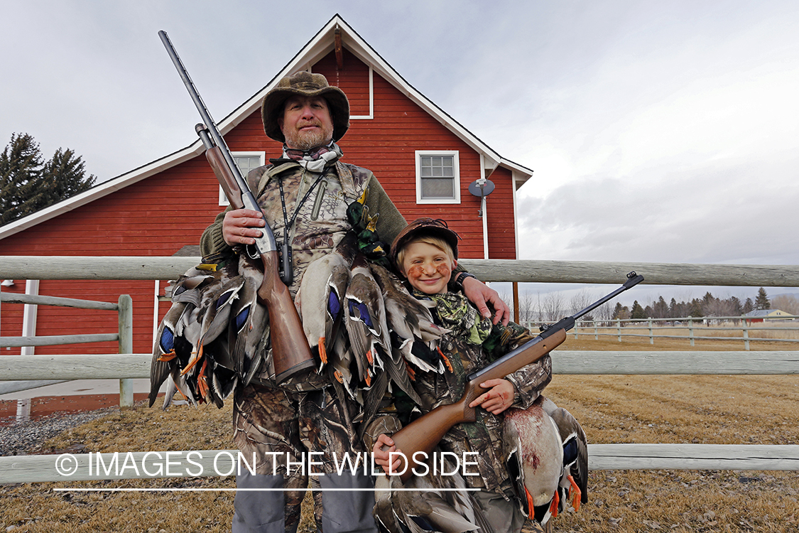 Father and son with bagged waterfowl.