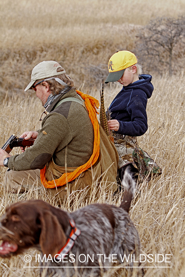 Father and son pheasant hunting. 