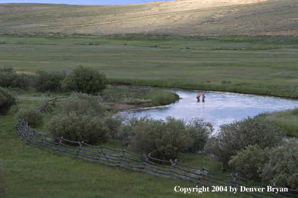 Flyfishermen fishing river.