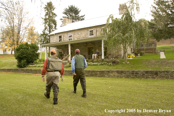 Flyfishermen walking toward club house from spring creek.