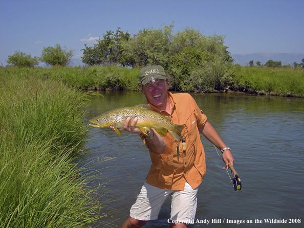 Flyfisherman with nice brown trout catch