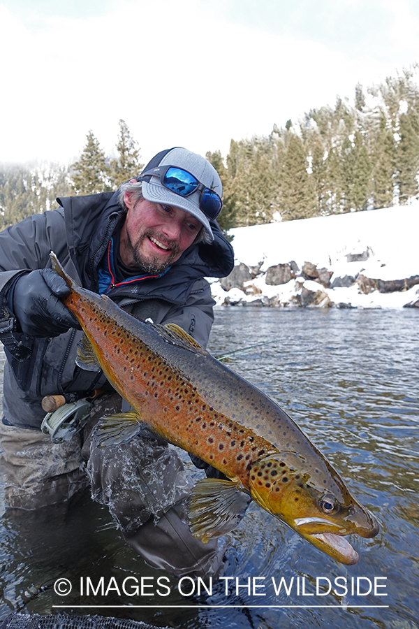 Flyfisherman with brown trout.