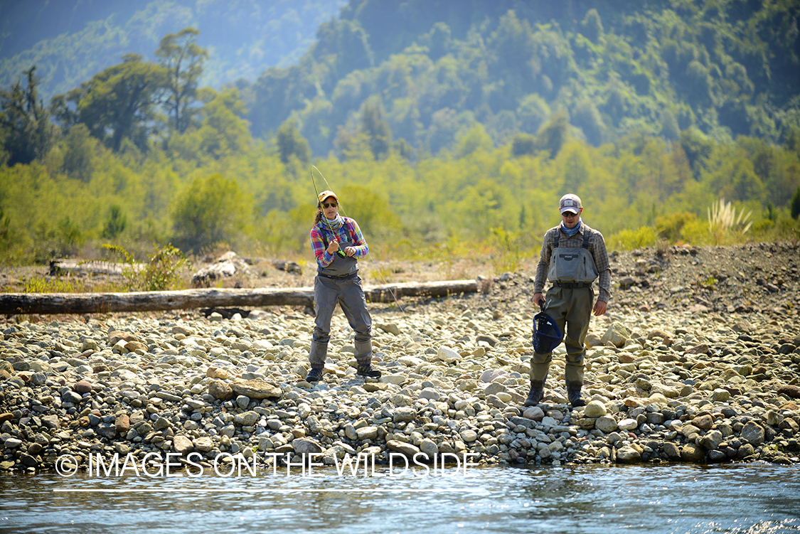 Flyfishermen on river in Chile.