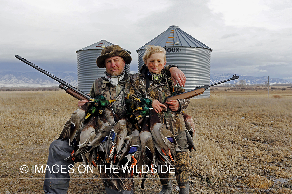 Father and son with bagged waterfowl.