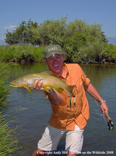 Flyfisherman with nice brown trout catch