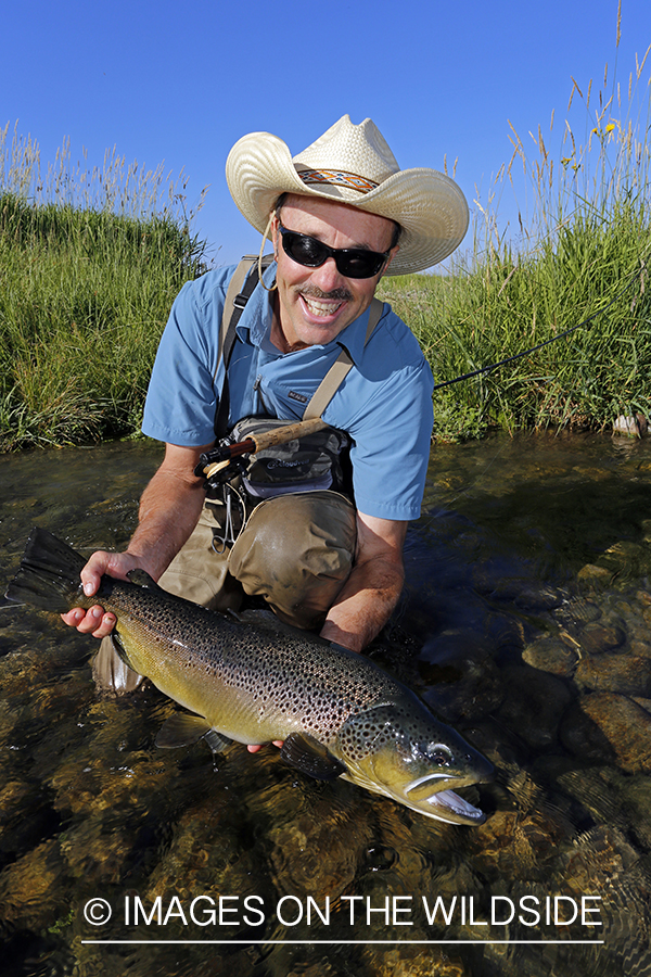 Flyfisherman with large brown trout. (10lbs)