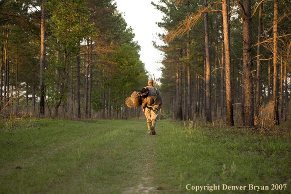 Turkey hunter in field with bagged bird