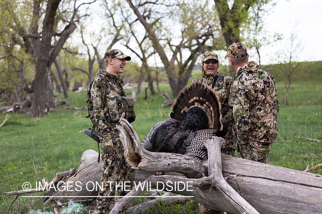 Hunters with bagged turkey.