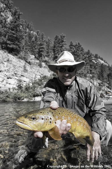 Flyfisherman with Brown trout. 