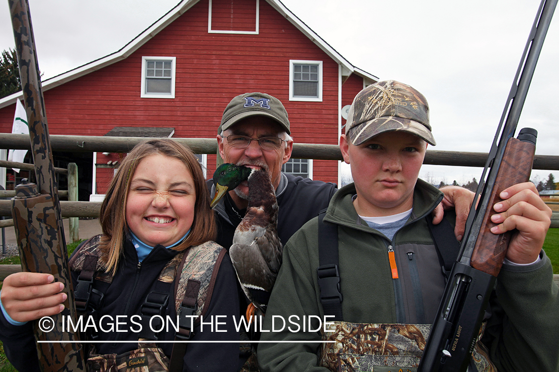 Father, son, and daughter after hunting trip.