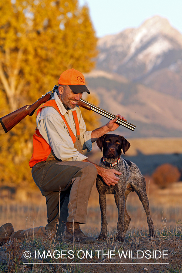 Upland game bird hunter in field with Griffon Pointer.