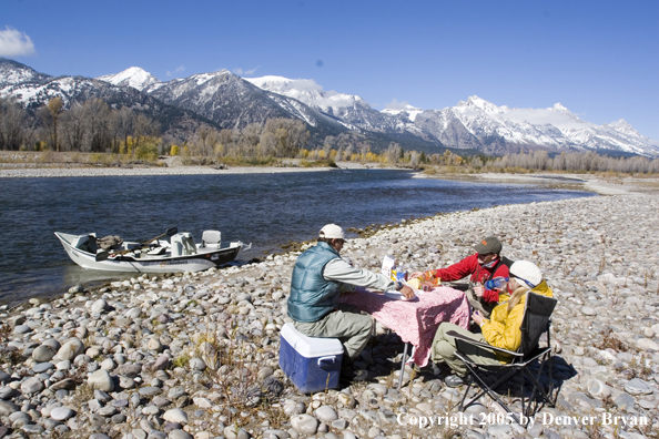 Flyfishermen eating on the banks of the Snake River.