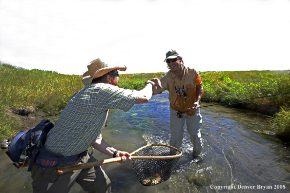 Flyfishermen fishing stream 