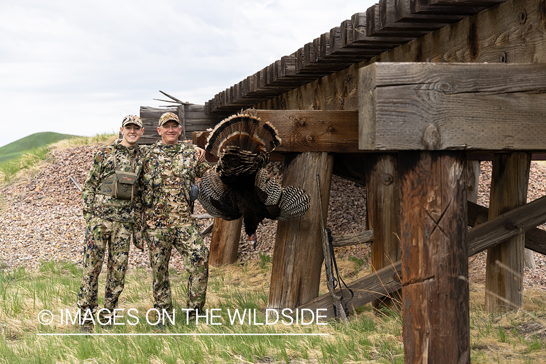 Hunters with bagged turkey.