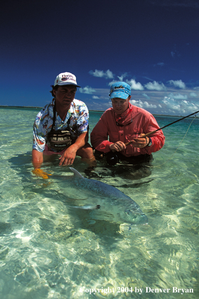 Saltwater flyfishermen releasing trevally.