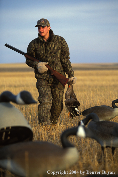 Waterfowl hunter with bagged White-fronted goose.