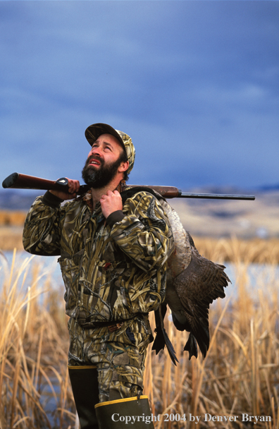 Waterfowl hunter with bagged White-fronted goose.