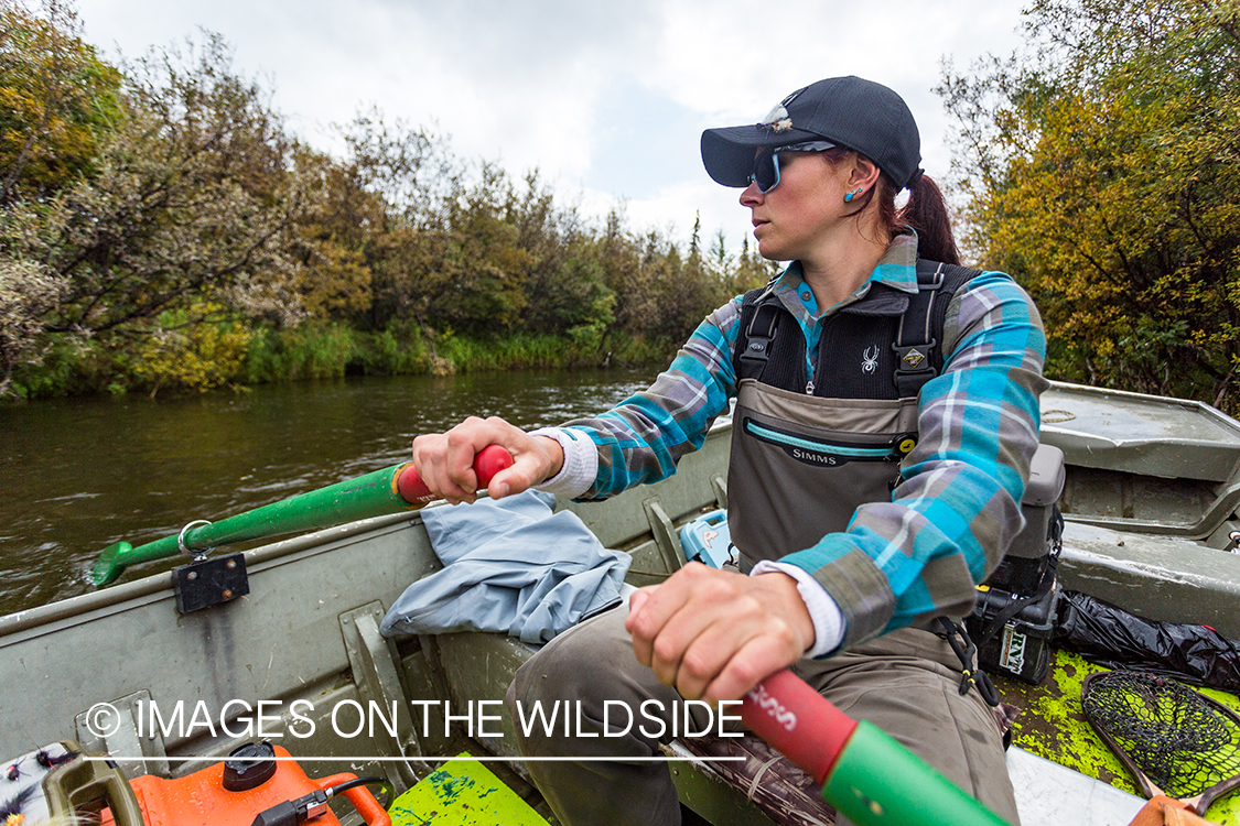 Flyfisher Camille Egdorf in boat on Nushagak river, Alaska.