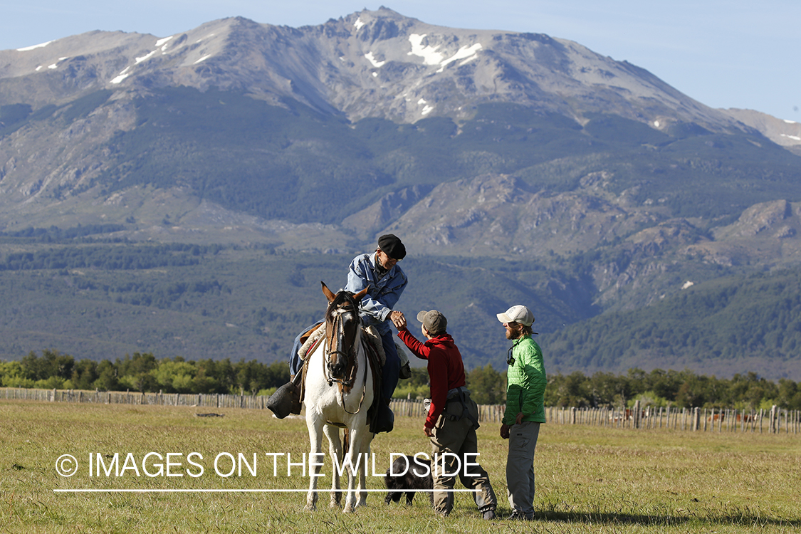 Flyfishermen talking to local on horseback.