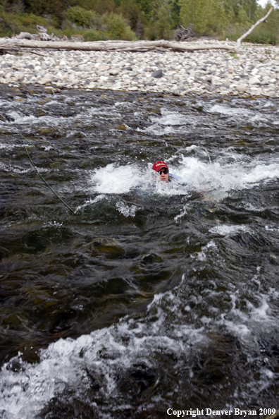 Flyfisherman caught in rapids