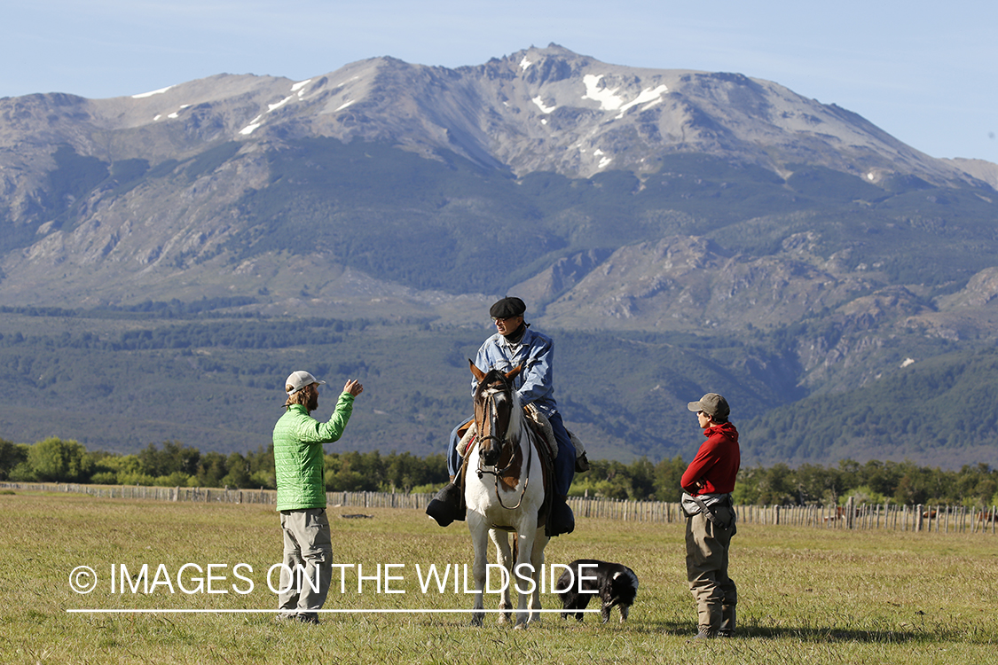 Flyfishermen talking to local on horseback.