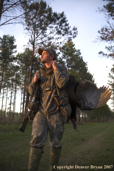 Turkey hunter in field with bagged bird