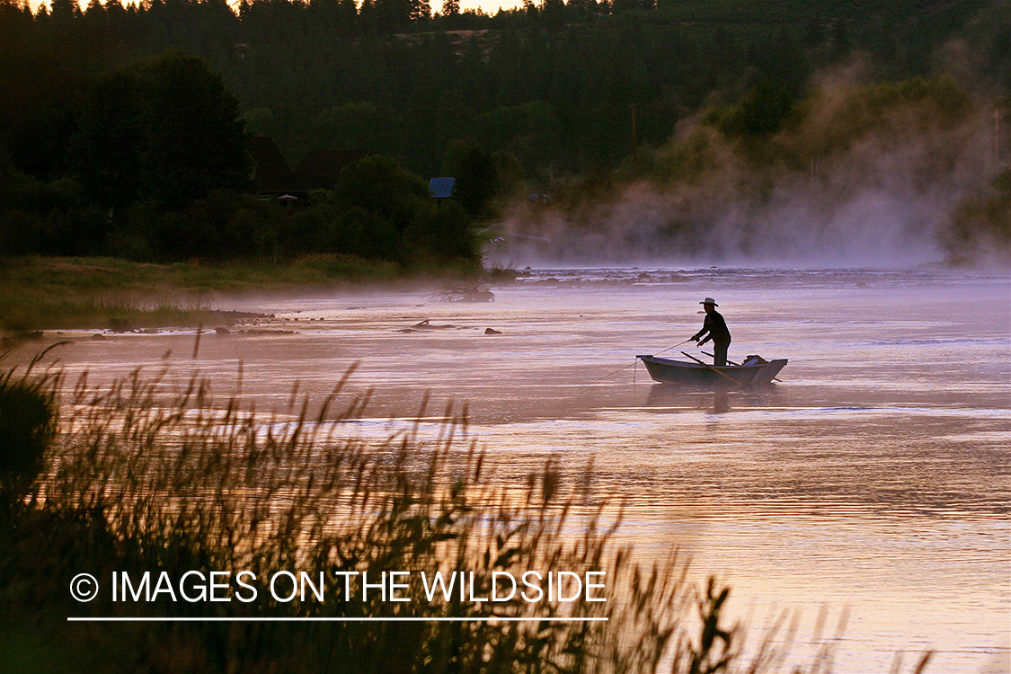 Flyfisherman casting in drift boat on Klamath River.