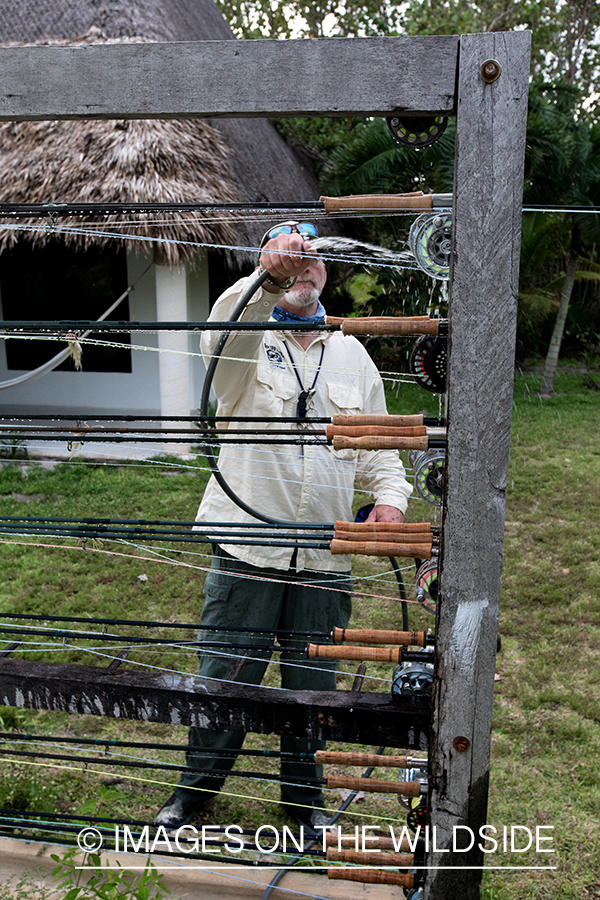 Flyfisherman washing fly rods.