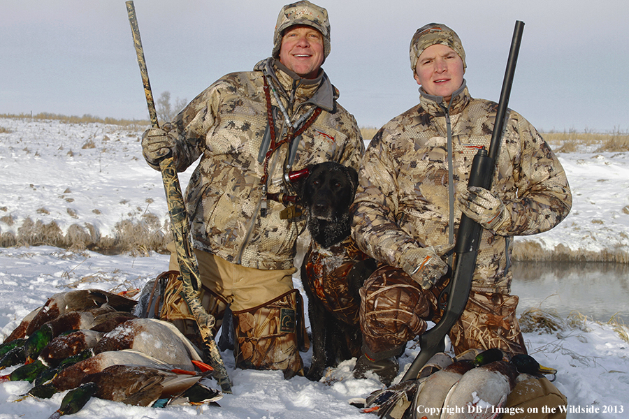 Waterfowl hunters with dog and downed waterfowl. 