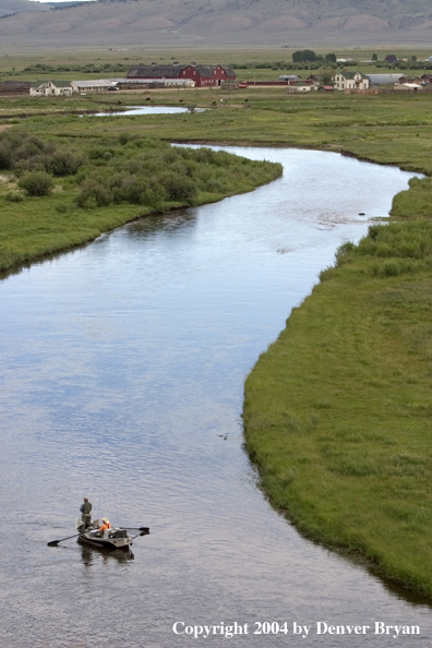 Flyfishermen fishing river from drift boat.