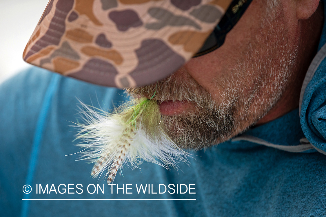 Flyfisherman with fly.