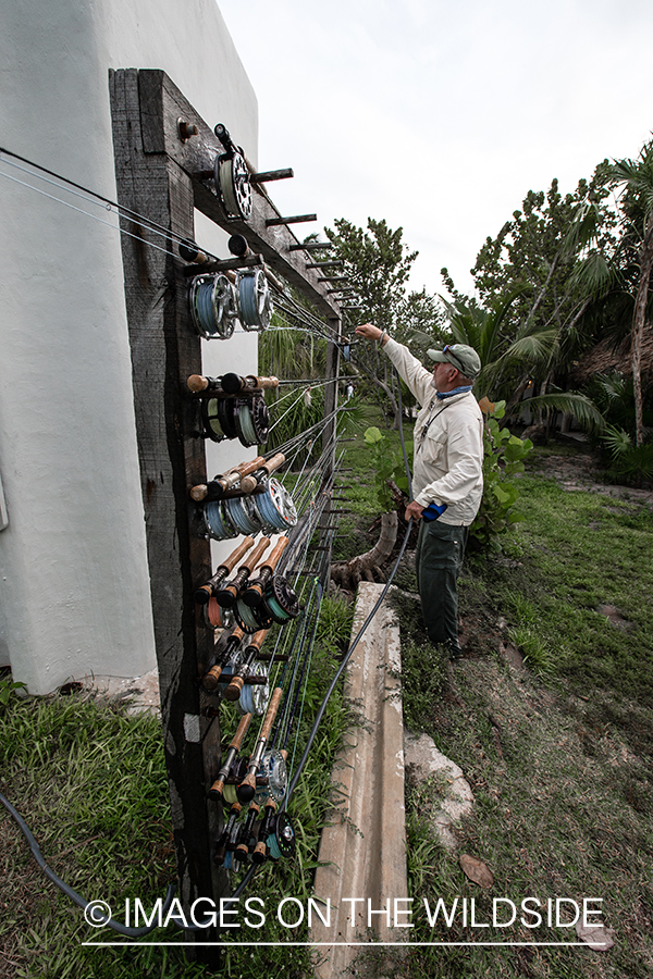 Flyfisherman choosing a fishing rod.