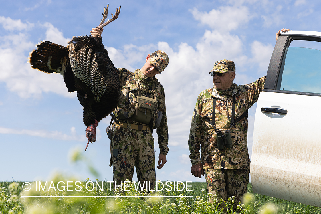 Hunters with bagged turkey.