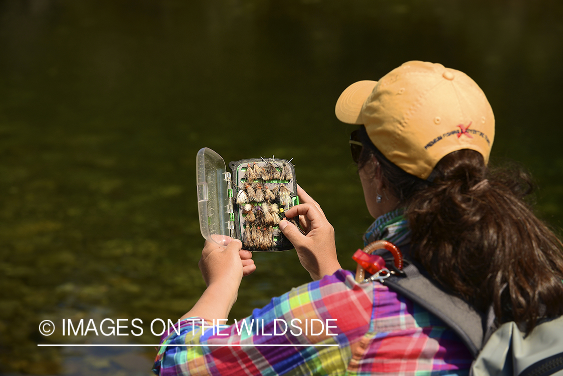 Flyfishing woman choosing fly.