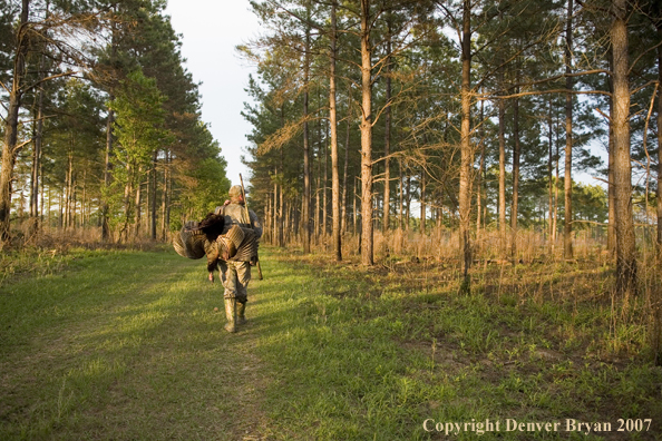 Turkey hunter in field with bagged bird