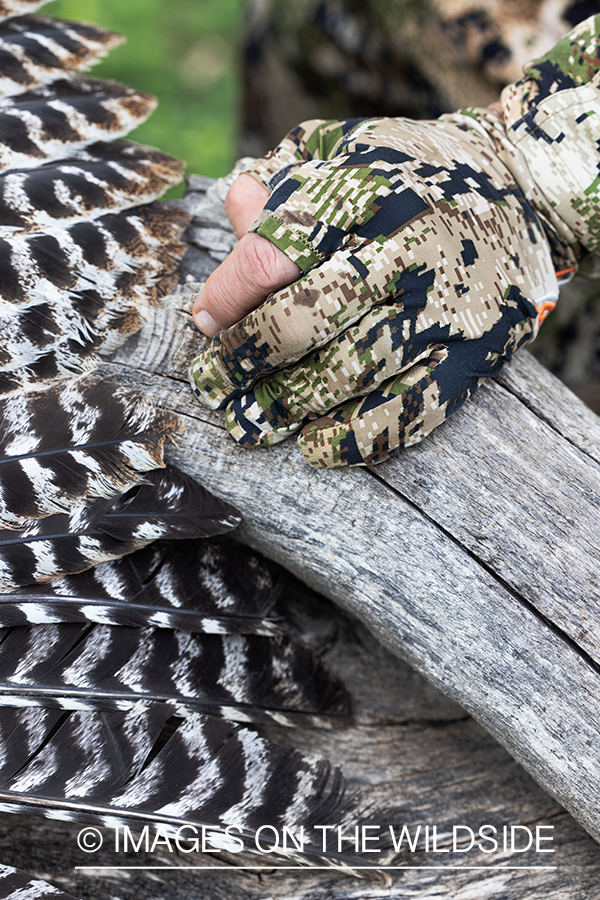 Hunter with close up of turkey feathers.