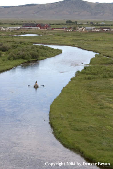 Flyfishermen fishing river from drift boat.  Summer.