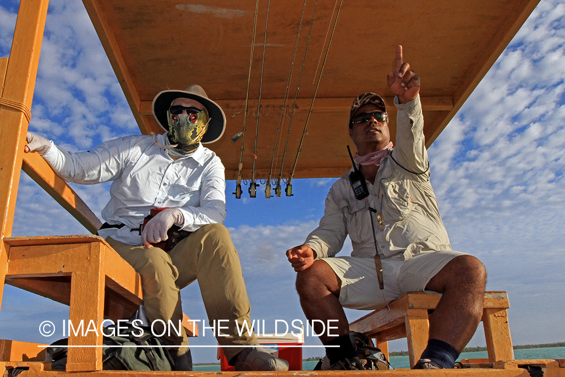 Saltwater flyfisherman with guide on boat, Christmas Island.