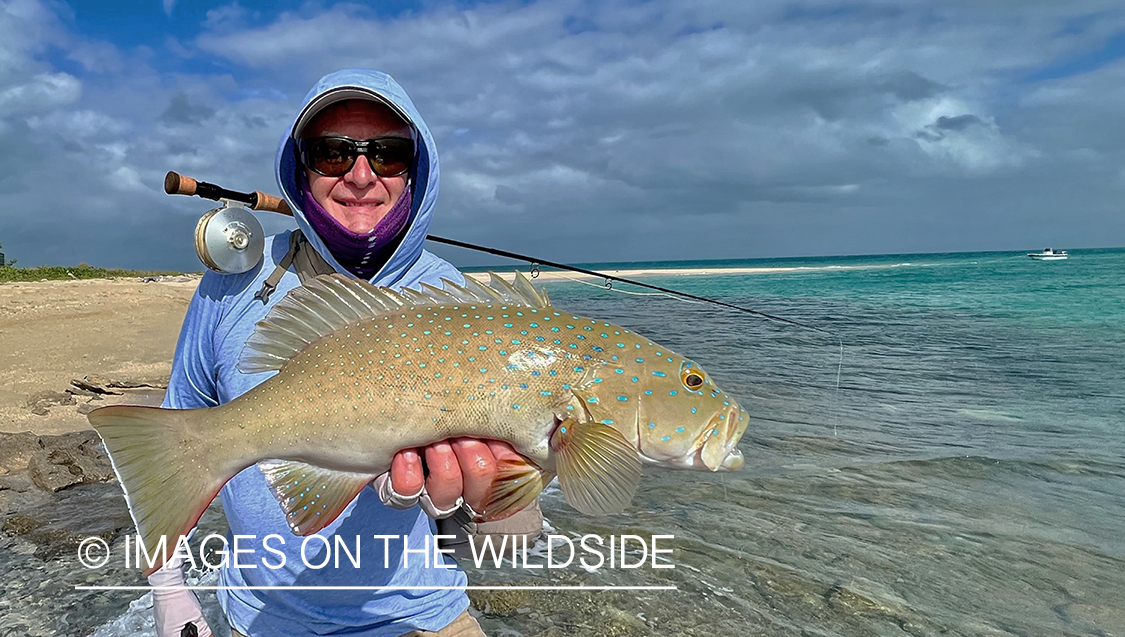 Flyfisherman with leopard coral grouper.