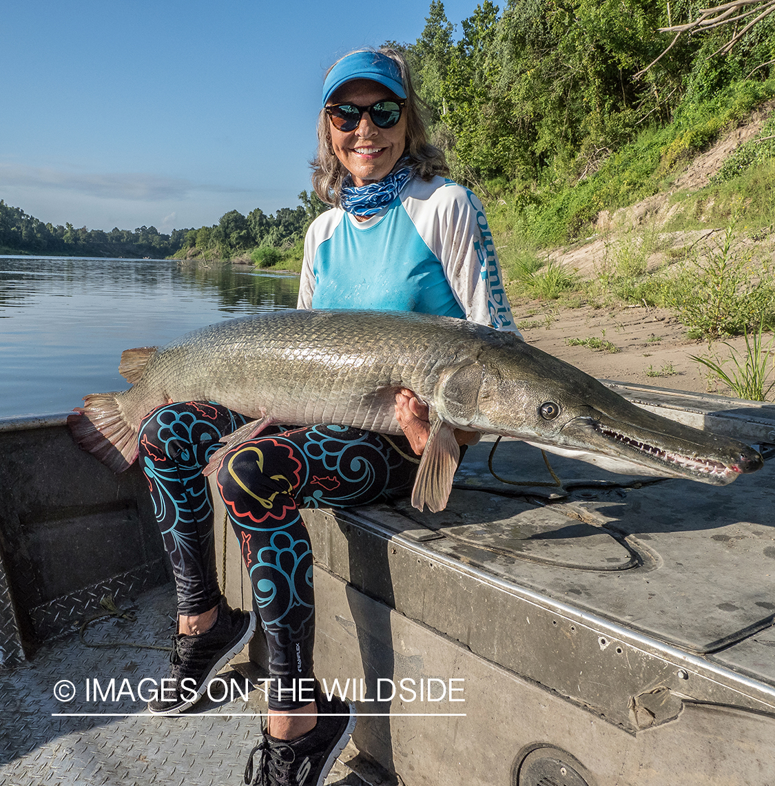 Female flyfisherman with Alligator gar.