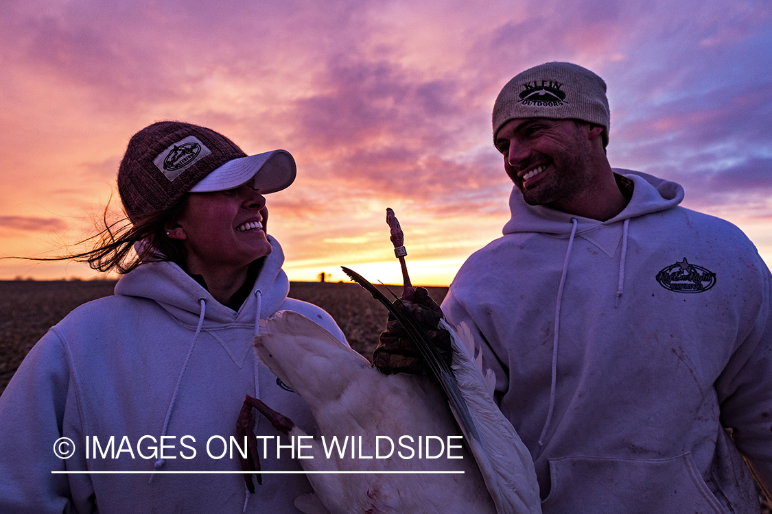 Hunters with bagged goose. 
