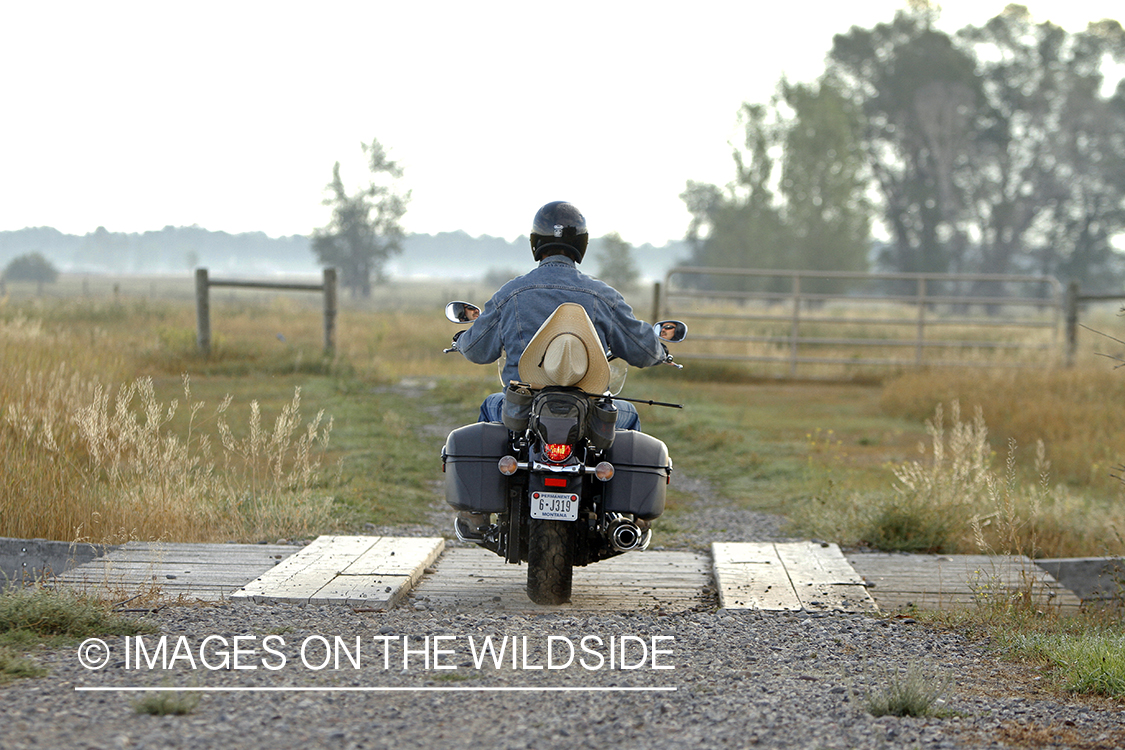 Flyfisherman on motorcyle.