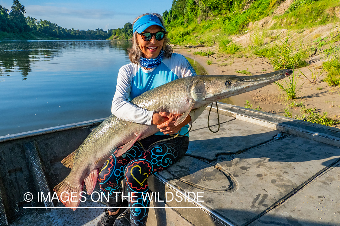 Female flyfisherman with Alligator gar.