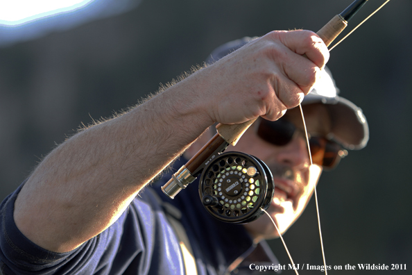 Close-up of flyfisherman casting.