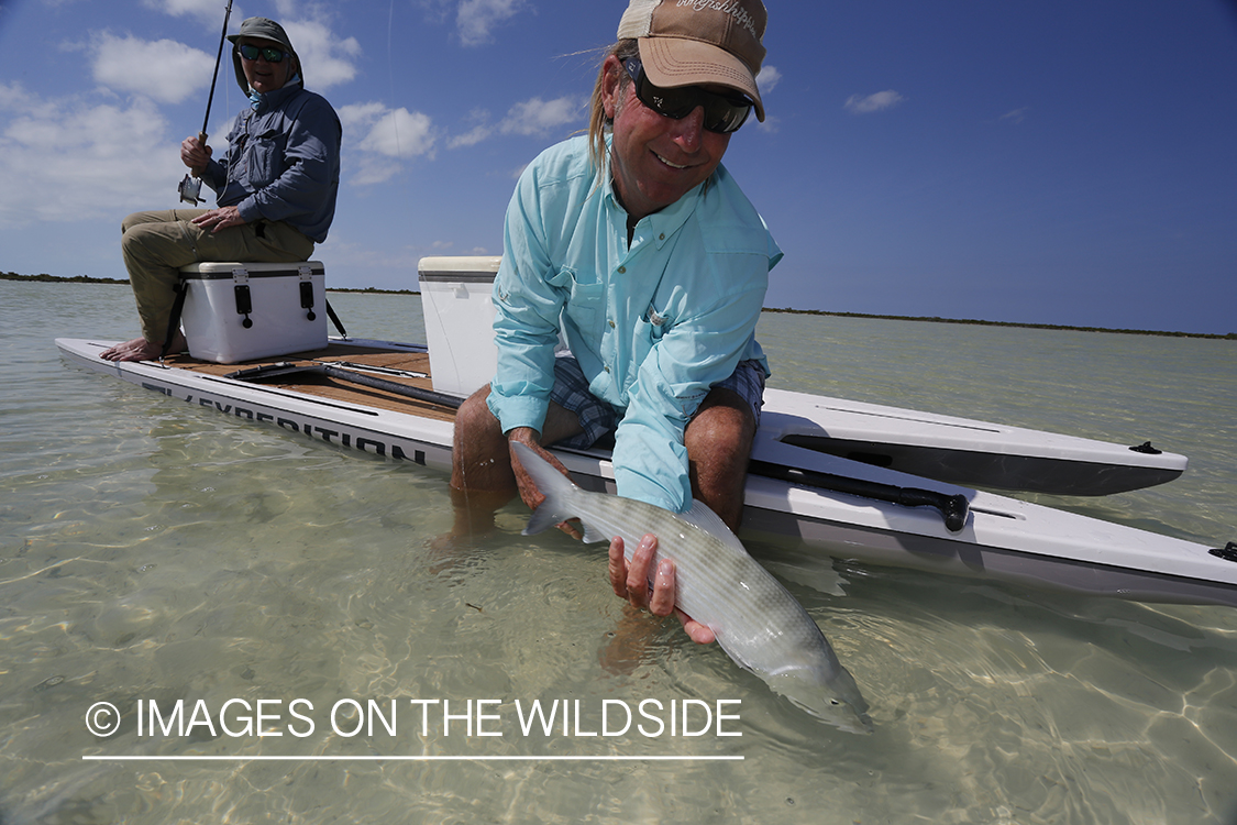 Flyfisherman landing bonefish.