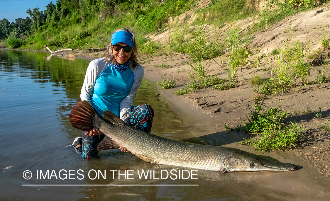 Female flyfisherman with Alligator gar.