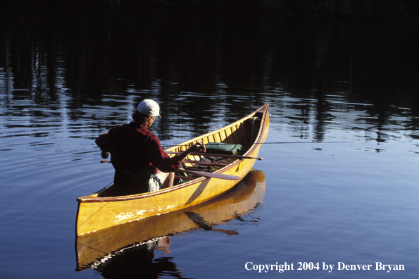 Flyfisherman fishing from cedar canoe.