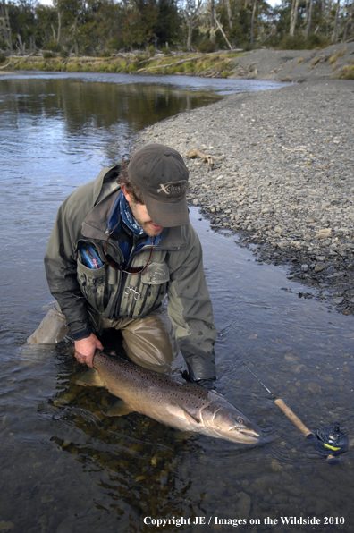 Flyfisherman with nice brown trout