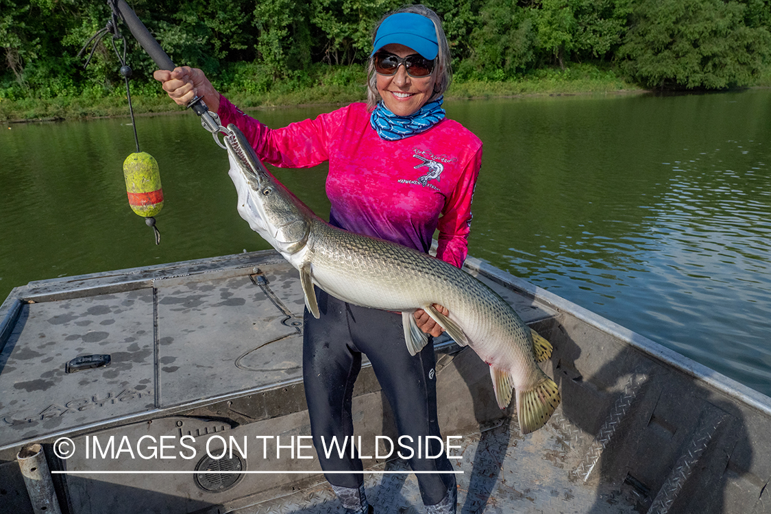 Female flyfisherman with Alligator gar.