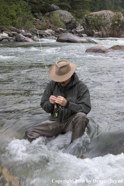 Flyfisherman fishing water pocket in river.